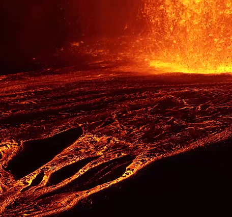 Color photograph of lava channels flowing away from lava fountain