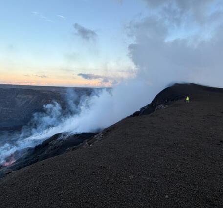 Color photo of the southwest side of Halemaʻumaʻu crater at the large tephra deposit that has grown since December 2024.