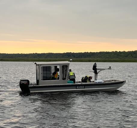 USGS research boat on river at dawn