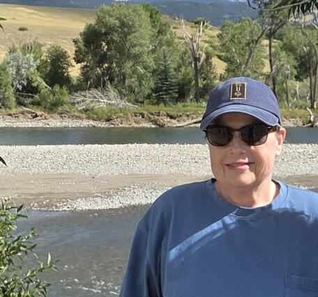 headshot portrait of Jaime McBeth in Yellowstone with stream and mountains in background