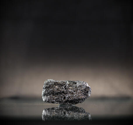 High-definition image of silicon metal specimen with shiny surface and granular structure.