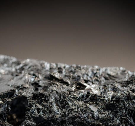 Macro image of silicon metal specimen showing detailed texture and metallic surface.