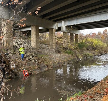 Hydrologic technician prepares to collect a streamflow measurement at a real-time streamgage location