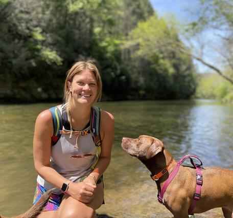 Woman by the water with her dog