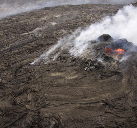 This is a steep aerial view of the small lava pond at the top of th...