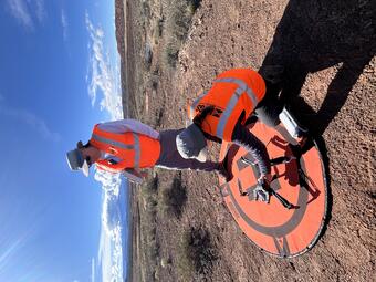 Two drone pilots set up equipment to be used in study near Moab, Utah