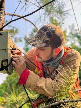 A researcher setting up an Anabat detector in the field