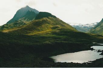 mountain peaks with lake in foreground
