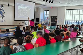 Donya Frank-Gilchrist presenting coastal change hazards to elementary students at Midtown Academy.
