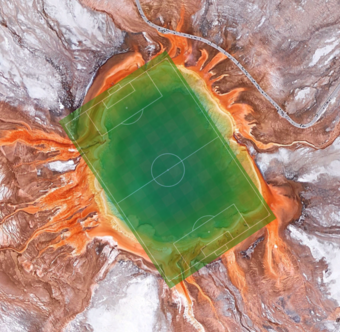 Aerial view of colorful Grand Prismatic Spring with a soccer field overlain and covering the spring's area almost exactly