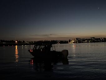 fieldwork boat on the water at dusk