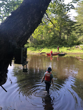Researchers with the Massachusetts Cooperative Fish and Wildlife Research Unit set trail cameras. 