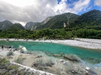 blue lake in foreground and mountains in the background