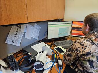 picture of a USGS scientists working at a computer