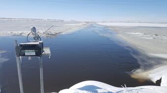A frozen USGS rapid deployment streamgage measures the height of the Maple River near Page, North Dakota.