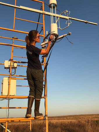 Scientist adjusts equipment mounted on tower at the Suisun Marsh in California. 