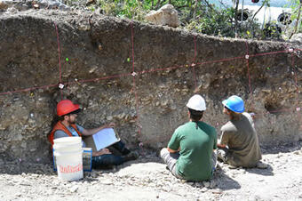 Paleoseismologists examining the trench walls at the Alpine site. Photo by Scott Bennett, 2014.