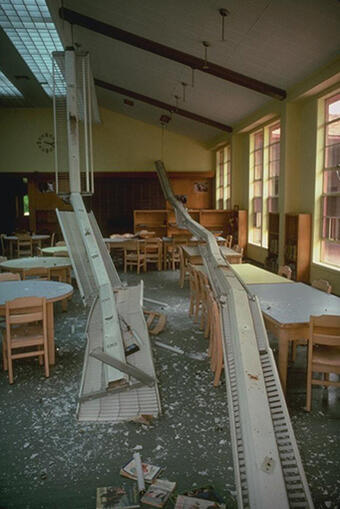 interior of building with banks of overhead lighting crashed on the floor