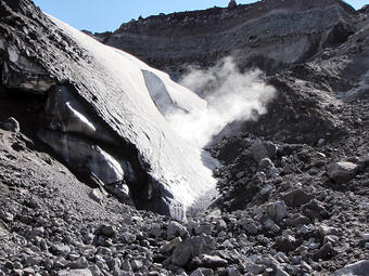 Steam rising from a hot spring in the crater of Mount St. Helens is...