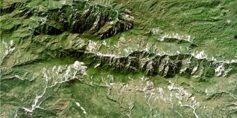 Areal view of rugged landscape with landslides visible on hillslopes