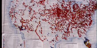 A paper map with many push pins showing observations of non-native aquatic species in the United States