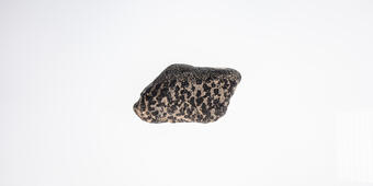 High-definition image of chromite specimen with visible crystal grains and dark coloration.