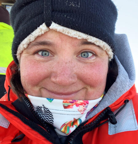 Researcher on a vessel wearing cold weather gear