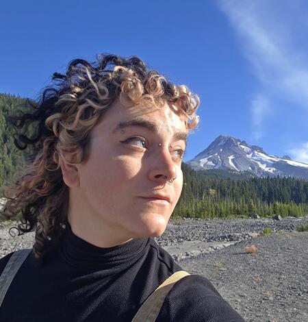 Woman with hat and flowing hair and life vest in profile picture