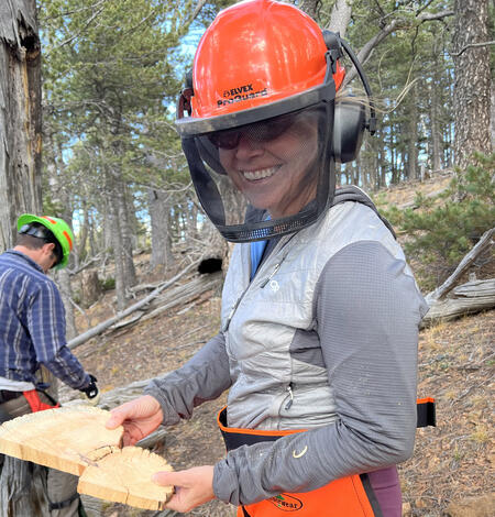 USGS Geographer Rebecca Brice displaying core taken from tree sample location