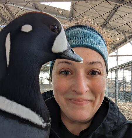 young woman wearing a headband holding a duck.