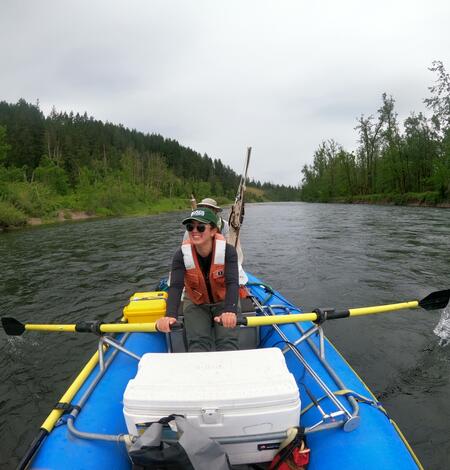 Girl paddling on raft on water