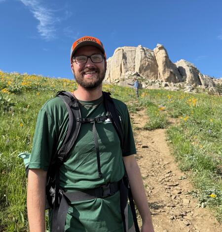 person standing in front of rock formation