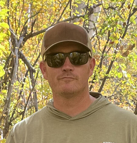 Photo of USGS employee, Matthew Hicklen, with fall foliage in the background