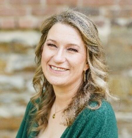 Headshot of Megan Elliott, wearing a green blouse.
