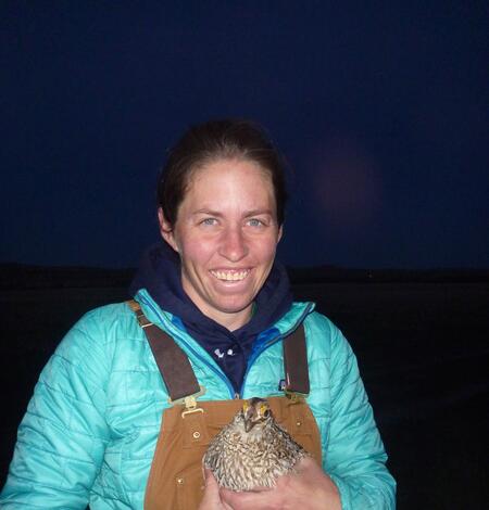 Megan Milligan holding a bird.