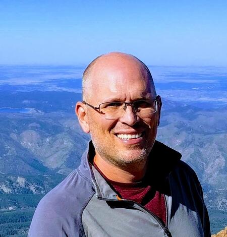 Mitch Bergeson in foreground, mountains in the background.