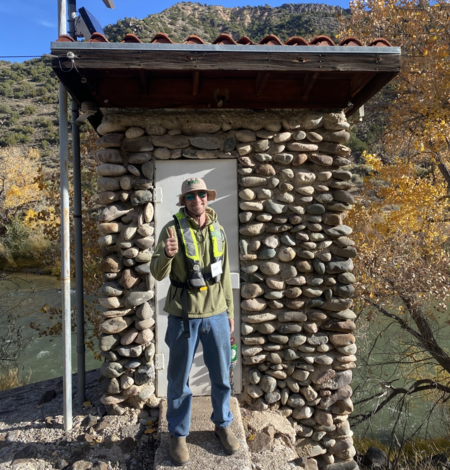 Image of Owen Bertany standing in front of a gage house
