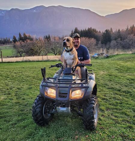 Man with dog on ATV