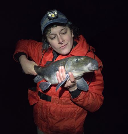 Scientist holding a Lost River Sucker fish