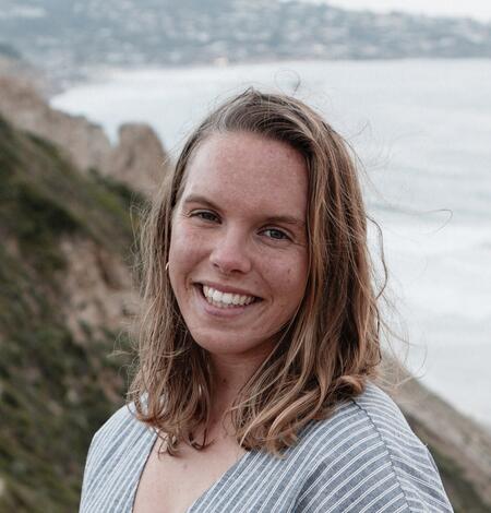 White woman with freckles and golden hair looking at camera
