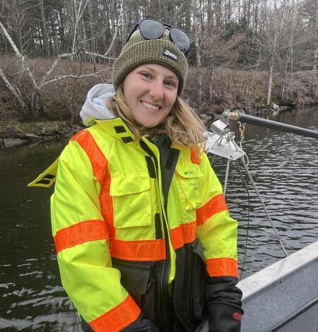 Young woman in boat wearing a PFD