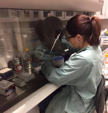 Woman in lab pipetting