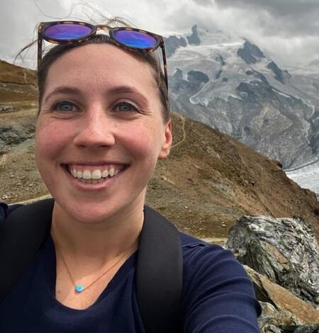 Emily Schmeltzer is a biologist wearing sunglasses on her head and blue shirt