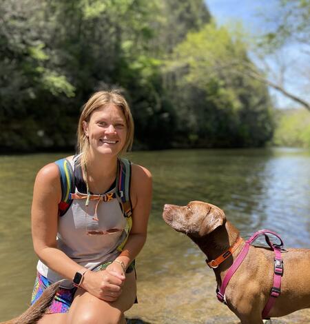 Woman by the water with her dog