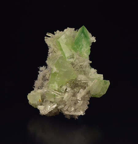 Image shows a sample of augelite and quartz on a black background.