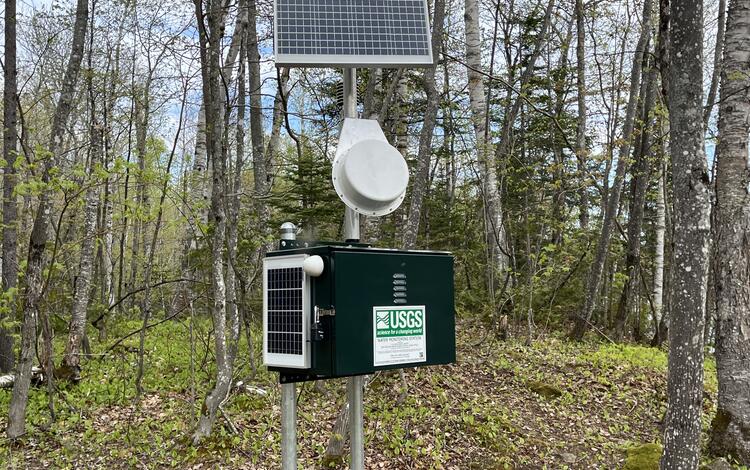 A streamgage in the woods.