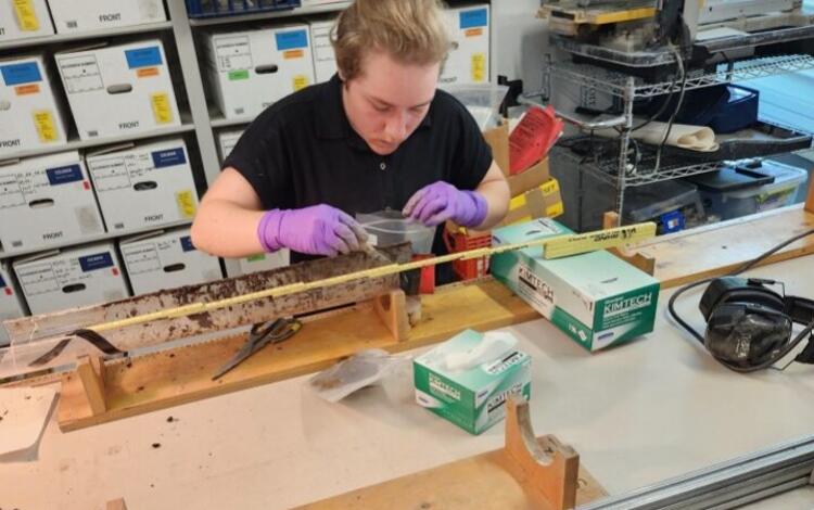 Person in a lab working with a sediment core