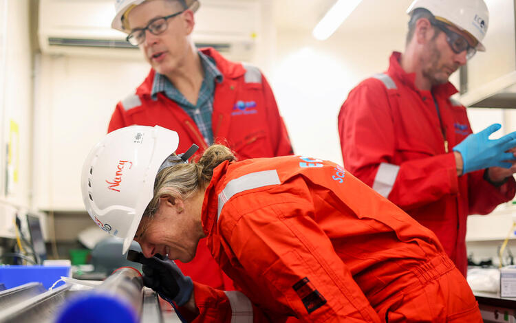 Aboard the Hawaiian Drowned Reefs Expedition, Nancy Prouty examines a coral core