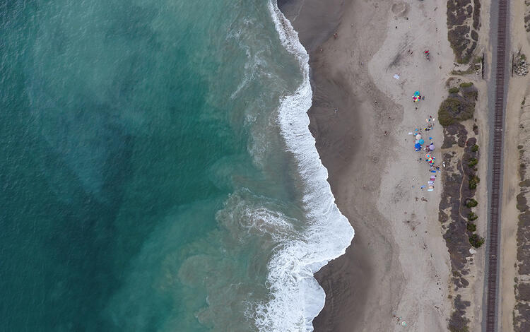 Photo showing aerial nadir view of a sandy shoreline in southern California