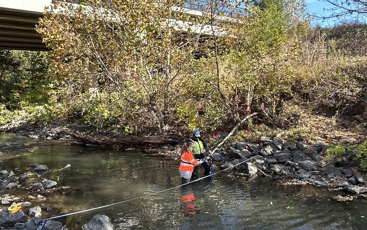 Two scientists collecting field parameter data as part of a water-quality cross section study